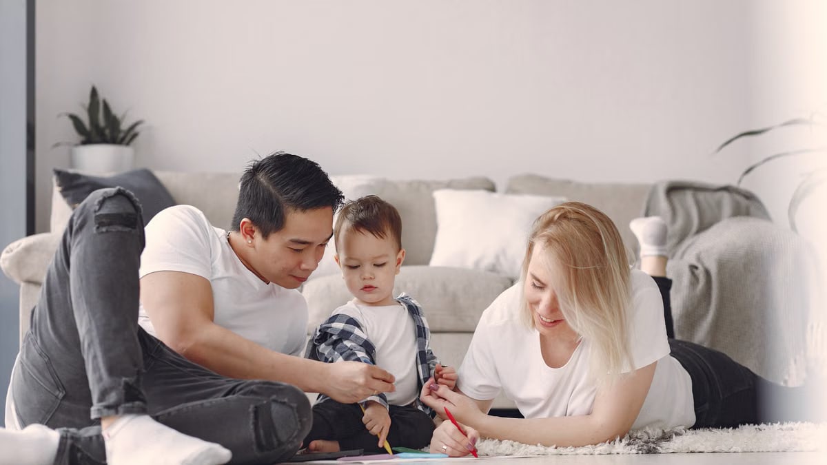 A joyful family drawing together indoors, fostering love and creativity.